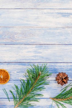 Yeni yıl Noel desen düz el yapımı elişi doku ile köknar ağacı çam kozalakları dalları Xmas tatil kurutulmuş portakal mavi ahşap arka plan kopya alanı şablonu için tebrik kartı üstten görünüm yatıyordu