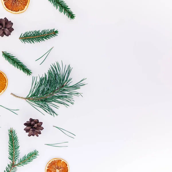 New Year Christmas pattern flat lay top view Xmas holiday handmade handicraft texture with fir tree pine branches cones dried oranges white background copy space Template for greeting card text design