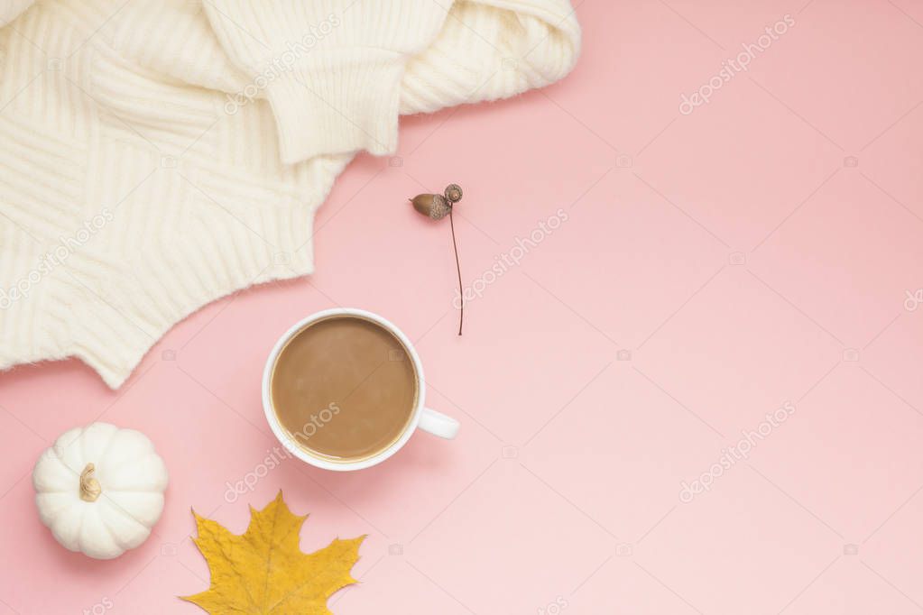 Creative autumn flat lay overhead top view coffee milk latte cup on millennial pink background copy space minimal style. Fall season template for feminine blog social media