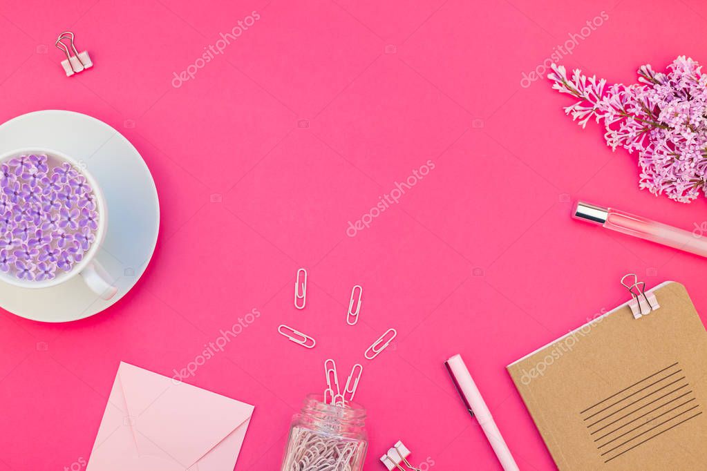 Creative top view flat lay of workspace desk styled design office supplies and cup of tea with copy space on a bright pink color paper background minimal style. Template for feminine blog social media