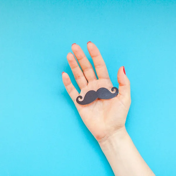 Creative square flatlay top view retro black paper photo booth props moustaches woman hands turquoise background copy space Men health awareness month fathers day masculinity concept blog social media