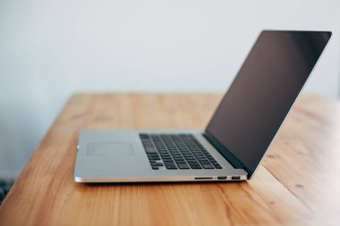 Rahat çalışma yerde ahşap masa ve modern dizüstü üzerinde döşeme ev ofis. Serbest çalışma kavramı