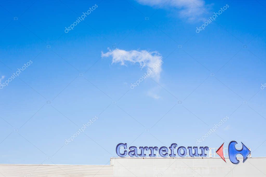 ORIHUELA, SPAIN - FEBRUARY 19, 2019: Carrefour supermarket chain brand logo at its building located in Orihuela shopping area, Spain. Clear bright blue sky