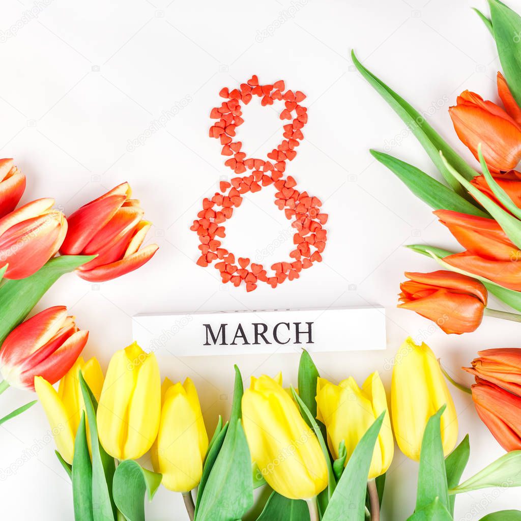 Creative flat lay top view 8 March International Women's Day greeting card with red tulips spring flowers on white background. Celebration Postcard template