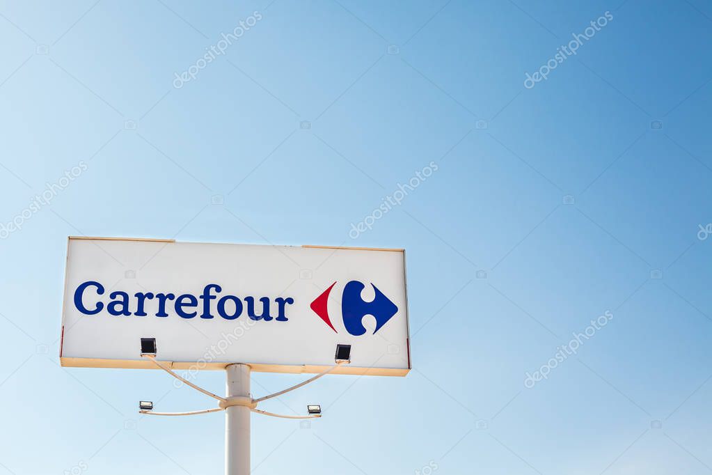 ORIHUELA, SPAIN - FEBRUARY 19, 2019: Carrefour supermarket chain brand logo at its building located in Orihuela shopping area, Spain. Clear bright blue sky