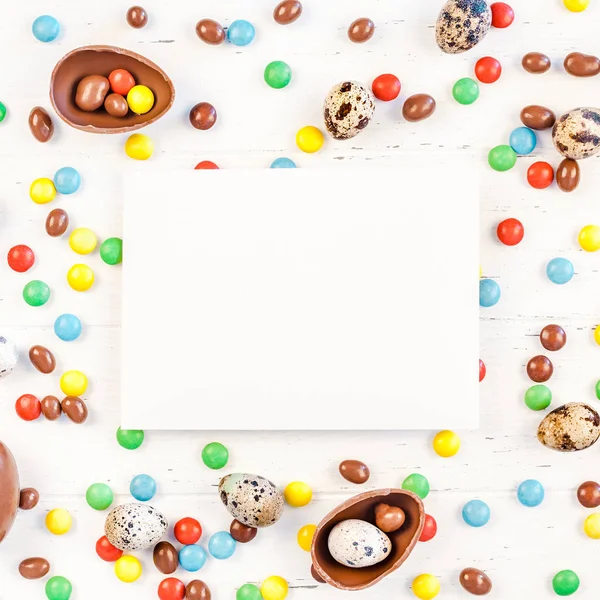 Easter frame with chocolate eggs, colorful candies