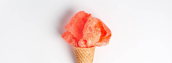 Coral lingerie in waffle cone on white background