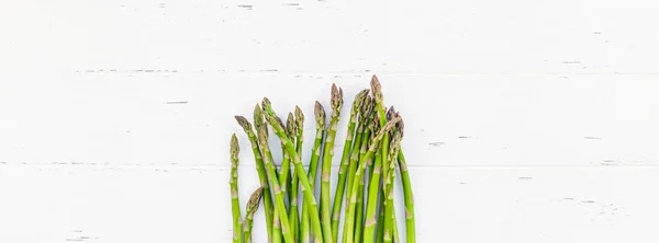 Fresh green asparagus on white wooden background — Stock Photo, Image