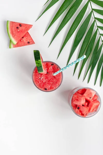 Watermelon smoothie with crushed fruits in glasses