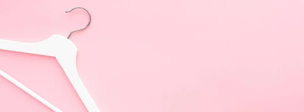 Белые вешалки на розовом фоне — стоковое фото