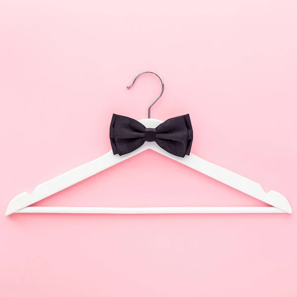White hangers on pastel pink background — Stock Photo, Image