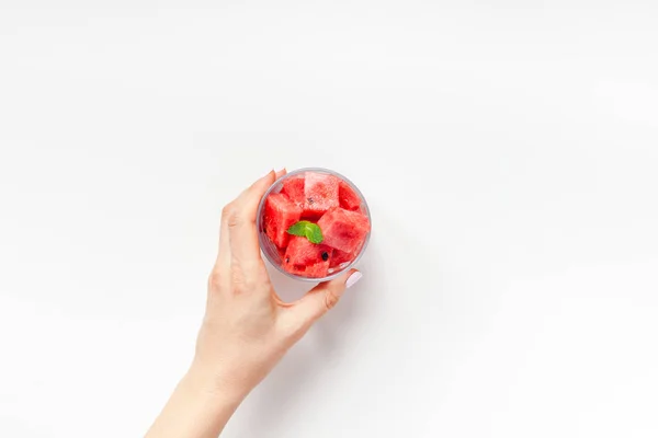 Woman hands with crushed watermelon in glass — Stock Photo, Image