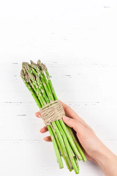 Verse groene asperges in vrouwenhanden — Stockfoto