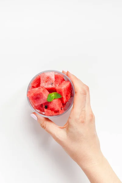 Woman hands with crushed watermelon in glass — Stock Photo, Image