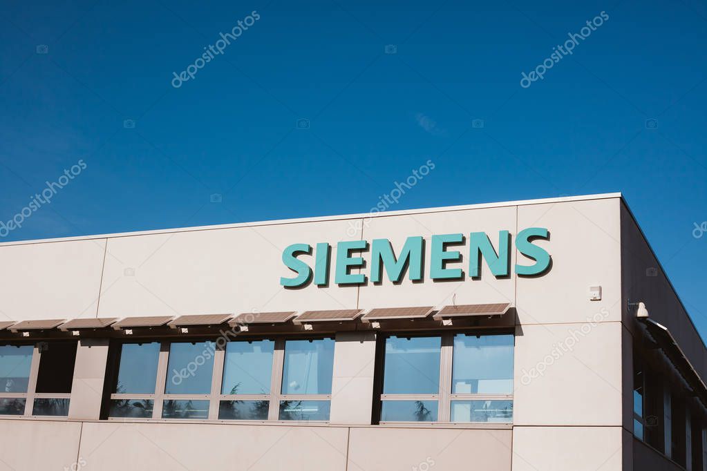 LYON, FRANCE - FEBRUARY 26, 2018: Siemens Company logo at its building located in business park in Lyon, France. Bright blue sky with copy space background