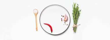 Yeşillik otlar ve baharatlar etrafında Boş plaka