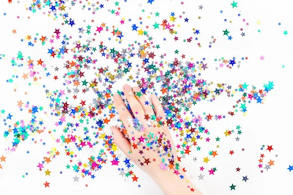Woman hand with festive color star confetti — Stock Photo, Image