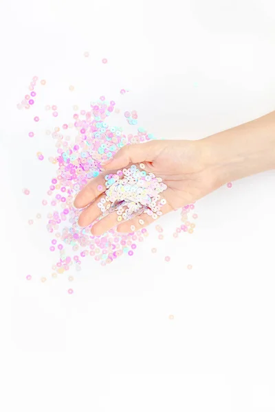 Pearl pastel confetti sparkles with woman hand — Stock Photo, Image