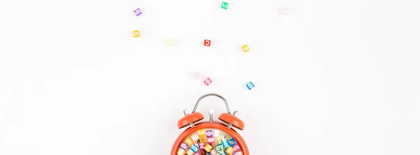 Alarm clock and multicolor alphabet — Stock Photo, Image
