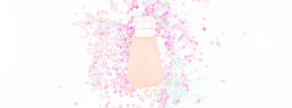 Cosmetic cream tube on pearl pastel confetti — Stock Photo, Image