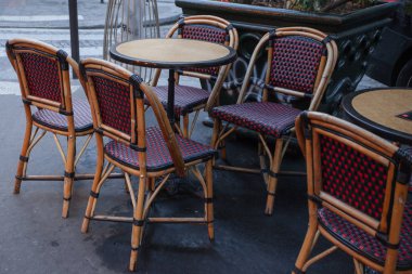 Saat bir Paris Arnavut kaldırımlı sokak boyunca yemek arasında boş tablolar