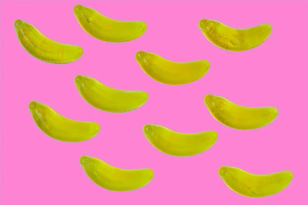 ピンク色の背景にバナナ イエロー ゼリー菓子 — ストック写真