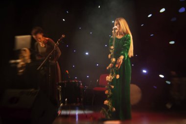 Genç sarışın kadın şarkıcı konser ışık