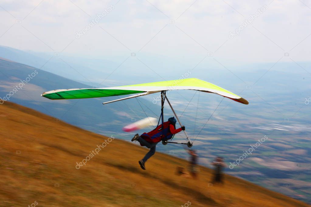 Hang glider pilot in Italian mountains 