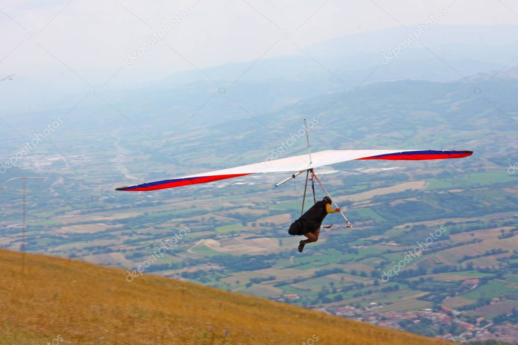 Hang glider pilot in Italian mountains 