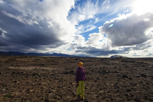 Happy tourist woman in bright coat, enjoying traveling Iceland — стоковое фото