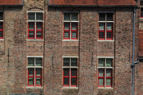 Red brick house facade with windows in Bruges, Belgium