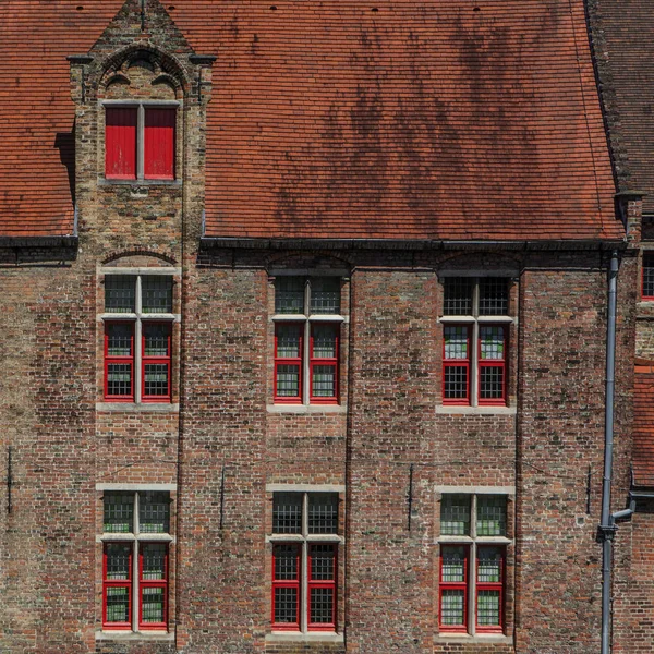 Red brick house facade with windows in Bruges, Belgium