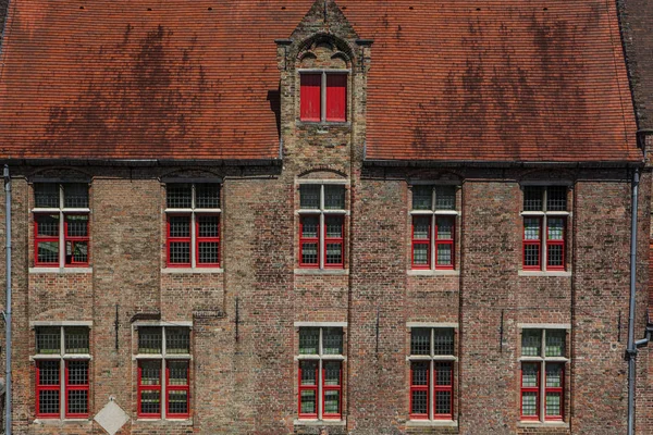 Red brick house facade with windows in Bruges, Belgium