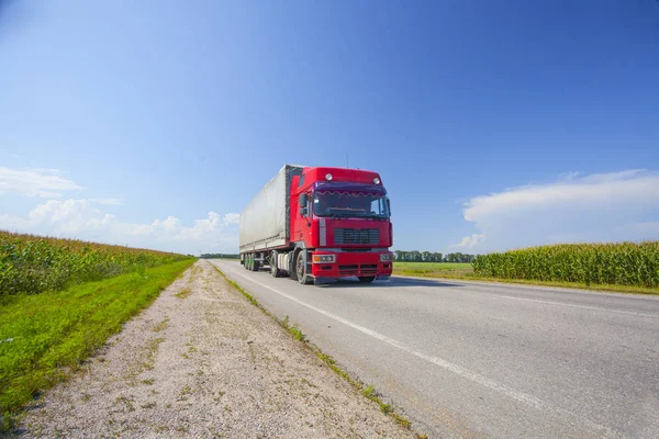 delivery truck outdoor on the highway ounder the blue cloudy sky  in Ukraine