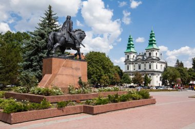 Ternopil, Ukraine - July 31 2009: Monument to king Danylo of Halych and Dominican Church in Ternopil, Western Ukraine. clipart