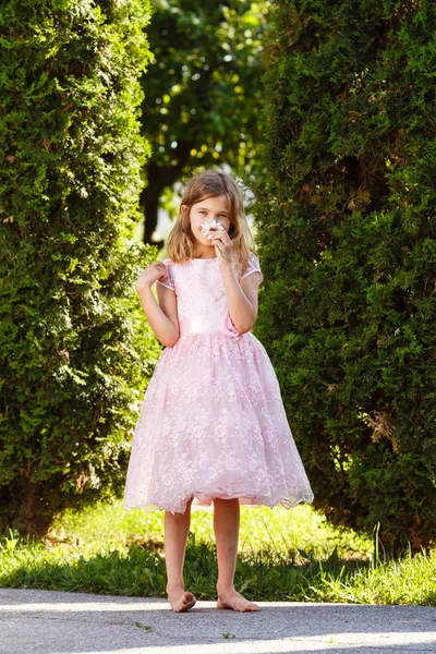 Girl Pink Lavish Dress Smells Flower Park Sunset — Stock Photo, Image