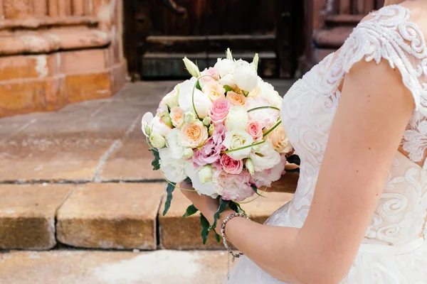 bouquet in the hands of the bride