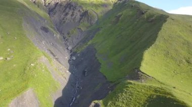 Drone havadan görünümden uçurumu ve kırık dağ Kazbegi, köy Stepantsminda Gürcistan yakınındaki dağlara