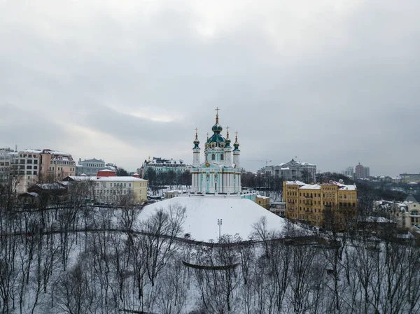 Famous touristic places in Kyiv - Aerial winter view to St Andrew\'s Church in capital of Ukraine and Podil region