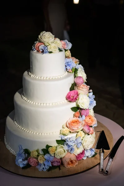 Soft Focus of wedding cake with fresh flowers and black background