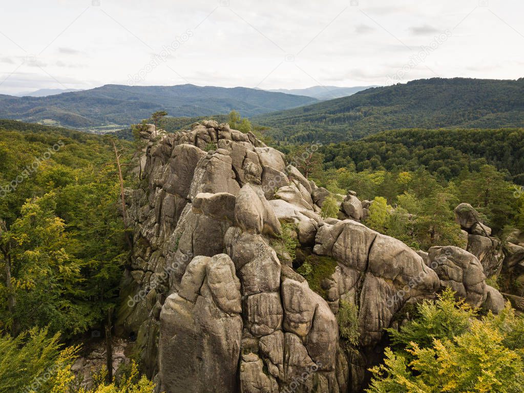 Aerial view to Dovbush Rocks in Bubnyshche - a legendary place, the ancient cave monastery in fantastic boulders amidst beautiful scenic forests, popular with tourists and travelers in Eastern Europe and Ukraine