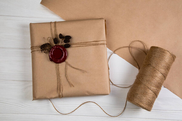 Gift wrapped in craft paper, tied with string and glued wax seal