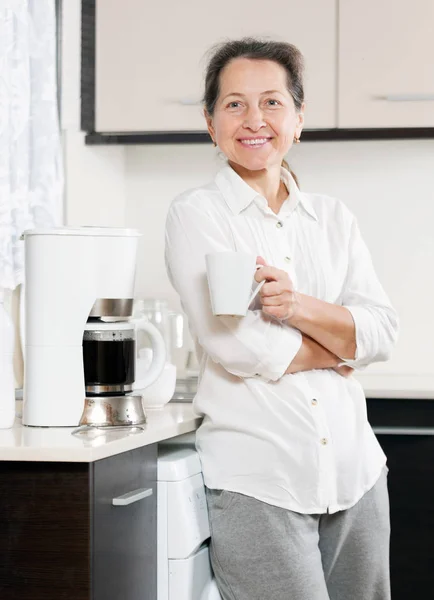 woman in   kitchen  near  coffee machine.