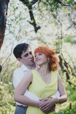 Çiçekli bahçeleri zemin karşı güzel evli çift portresi. 