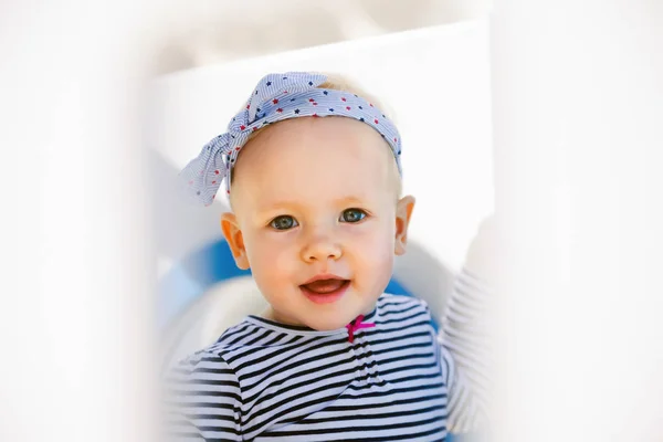 One year-old child   playing on   playground.