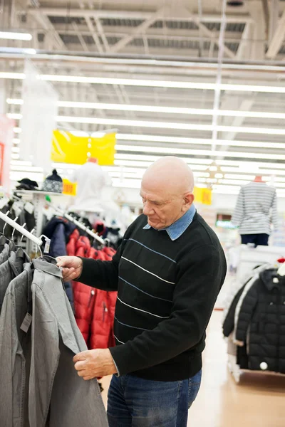 Senior man  shopping in   clothing store.