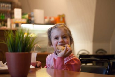 4 yaşındaki kız donut yiyor.  