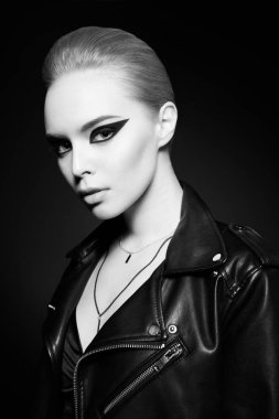 Woman with bright makeup in leather jacket