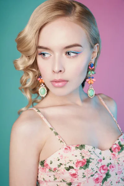 Mujer rubia con maquillaje de color sobre fondo colorido — Foto de Stock