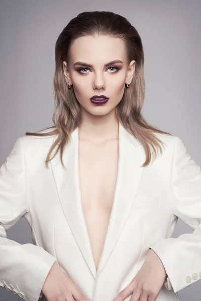 Elegant woman in white jacket